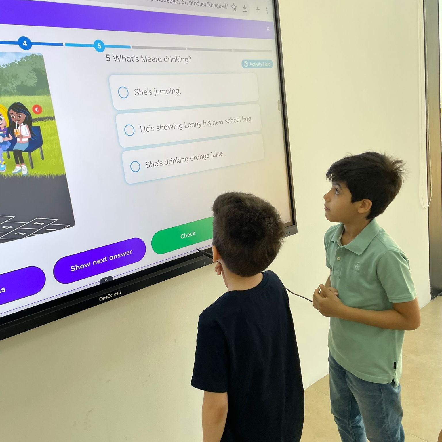 Two primary school boys learning English and playing language games on a smart board