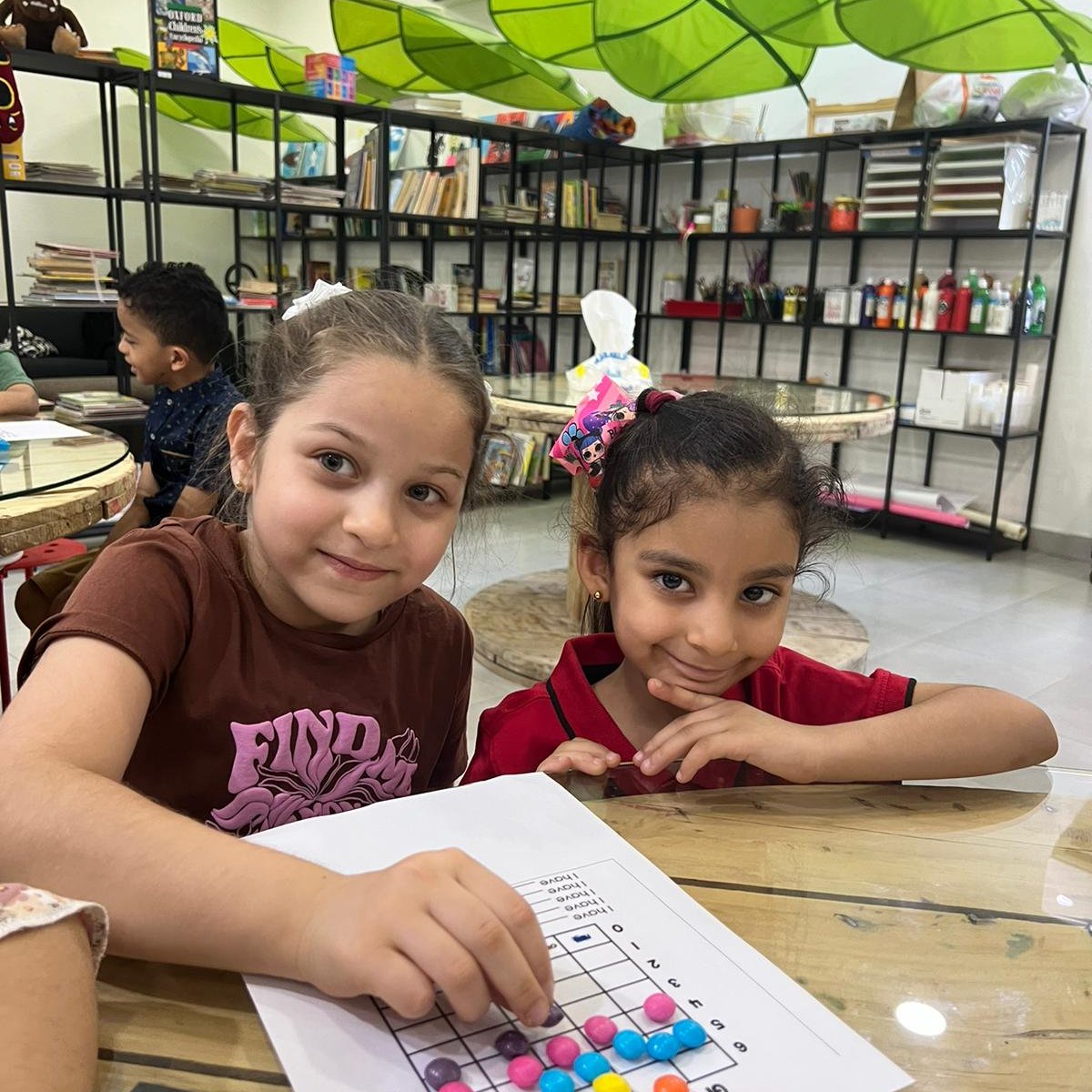 2 young students learning to read their sight words with candy as motivation